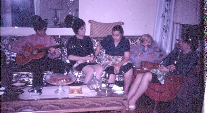 s011.jpg - Cousin Louie playing the guitar, Aunt Voula, giagia Chrissoula, and Mom, Nov. 1970.